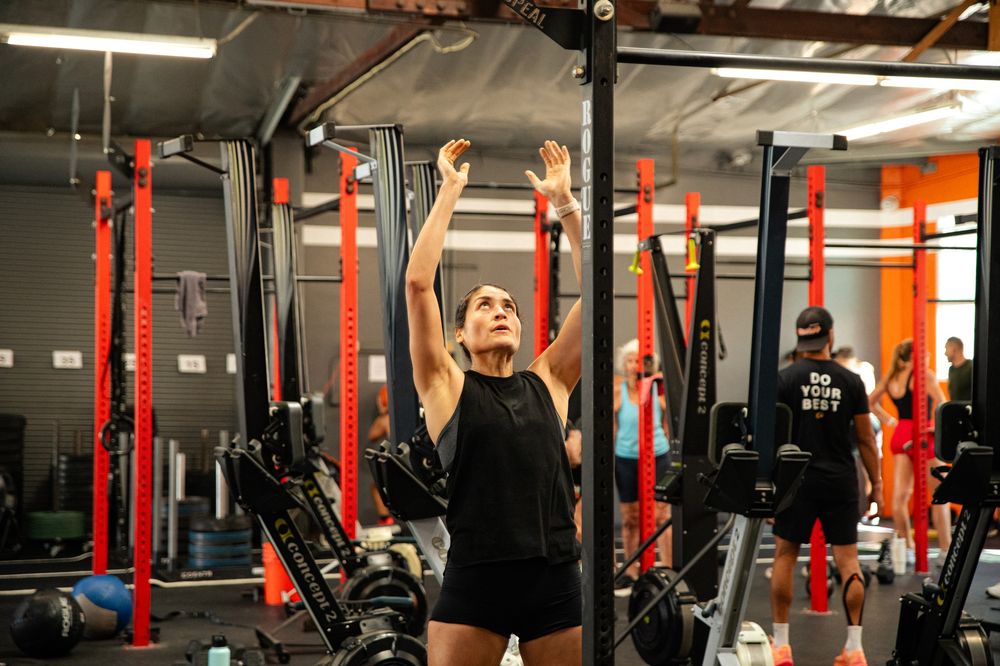 An athlete throwing a wall ball to the target during GWOD