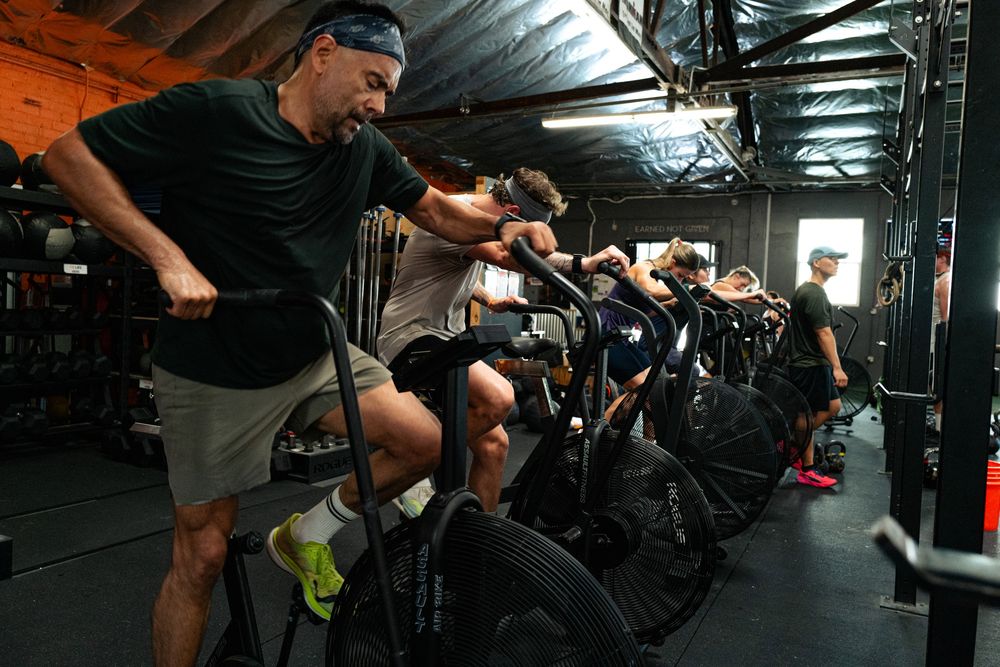 A row of athletes on air bikes during GWOD